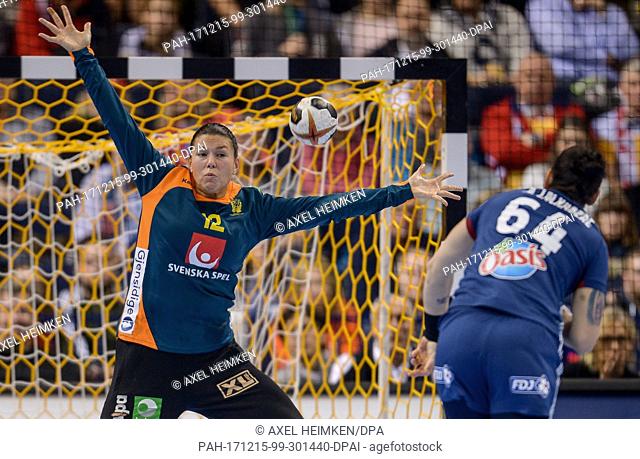 Sweden's Filippa Idehn (L) attempting to stop a shot by France's Alexandra Lacrabere during the 2017 World Women's Handball Championship semi-final match...