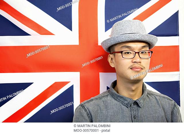 Portrait of a mid adult man against British flag