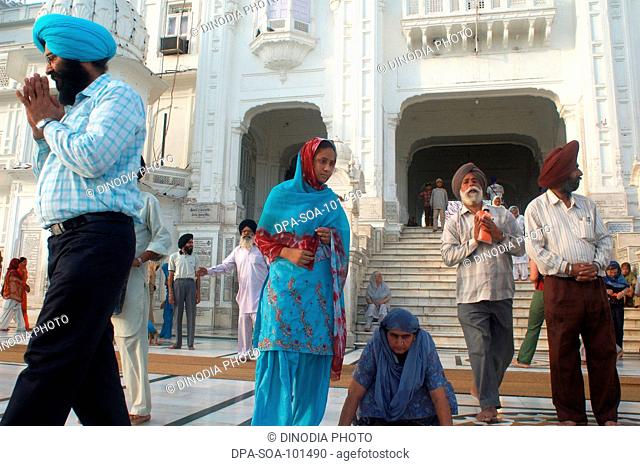 Sikh praying at golden temple ; Amritsar ; Punjab ; India