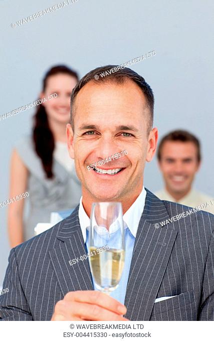 Successful businessman holding Champagne with his team