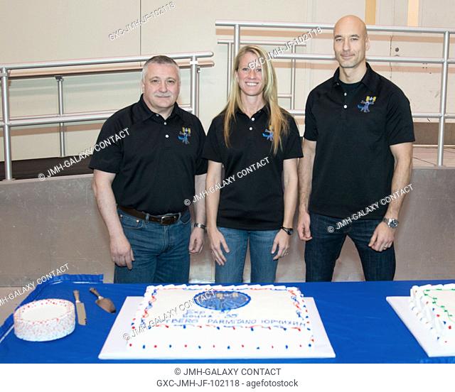 From left to right, Expedition 3637 crew members Fyodor Yurchikhin, Karen Nyberg and Luca Parmitano participate in a special cake cutting ceremony with their...