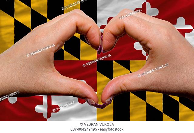 over american state flag of maryland showed heart and love gestu