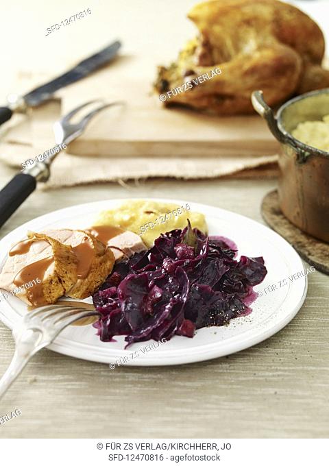 Crispy duck with red cabbage and apple and olives