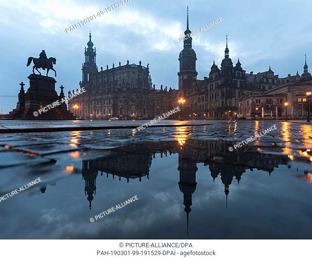01 March 2019, Saxony, Dresden: The equestrian statue of the Saxon king Johann (l.) on the Theaterplatz, the Hofkirche and the Residenzschloss with the...