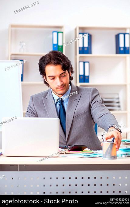 Young handsome businessman in budget planning concept