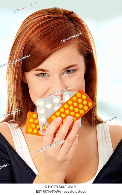 Young woman with pills
