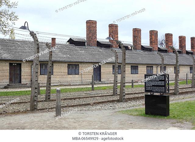 Electric barbed wire fence with barracks, death camp Auschwitz I, Auschwitz, Lesser Poland, Poland, Europe
