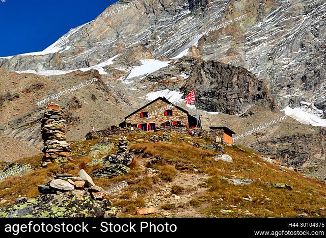 The Ar Pitetta mountain refuge in front of the great West wall of the Weisshorn in the southern swiss alps above Zinal