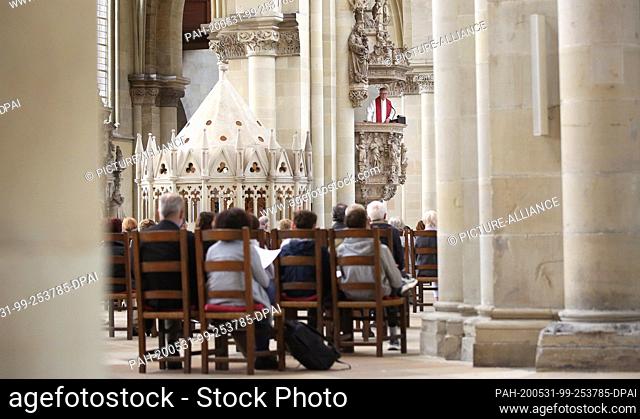 31 May 2020, Saxony-Anhalt, Magdeburg: Cathedral preacher Jörg Uhle-Wettler speaks to believers from the alabaster pulpit during the service on Pentecost Sunday...
