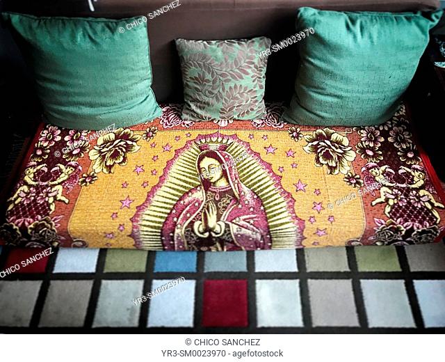An image of Our Lady of Guadalupe decorates a sofa in Mexico City, Mexico