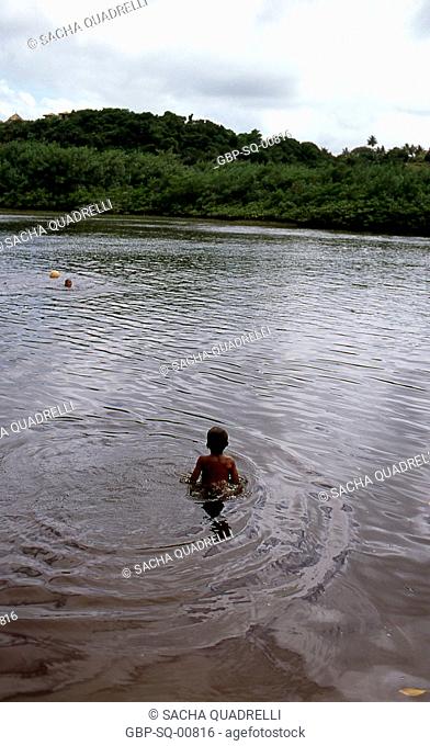 Boys swimming in the river, Caraíva, Bahia - Brazil