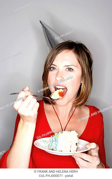 Woman eating birthday cake