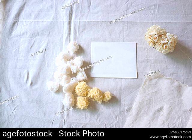 White paper and whit flower on white fabric , decoration background