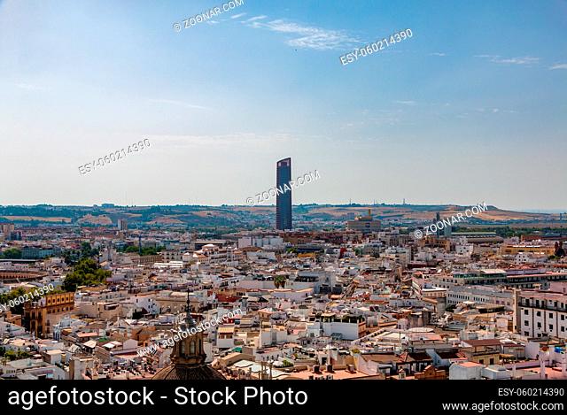 A picture of the Sevilla Tower centered around a rooftop view of the city