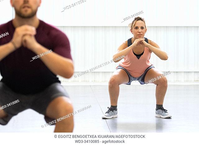 Young man and woman exercising