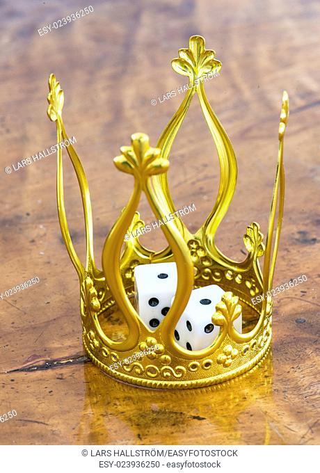 Golden crown and pair of dice. Concept of luck, success and fortune