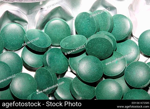 Medical green round vitamins spirulina platensis healthy super food close up background high quality big size prints