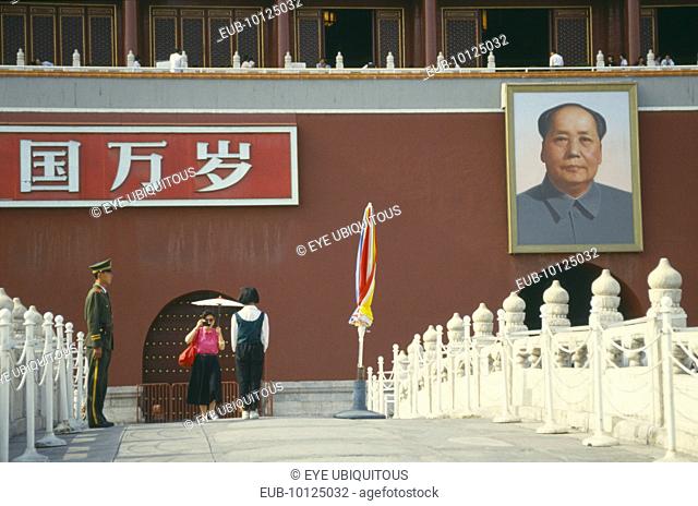 Policeman under picture of Chairman Mao