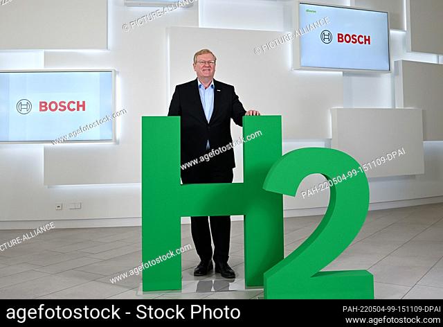 04 May 2021, Baden-Wuerttemberg, Renningen: Stefan Hartung, the chairman of the Bosch board of management, pictured in front of an H2 logo before the annual...