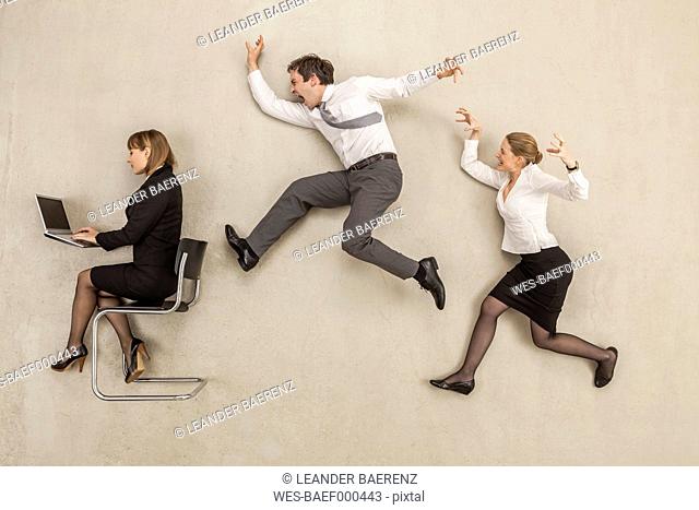 Business people chasing in office