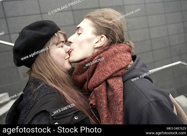young man licking face of woman