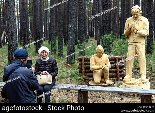 RUSSIA, IRKUTSK REGION - MAY 13, 2023: Visitors at the 10th Lukomorye Na Baikale international wood sculpture festival. As part of the festival