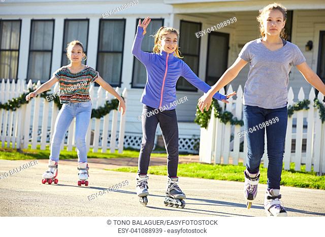 Teen girls group rolling skate in the street outdoor