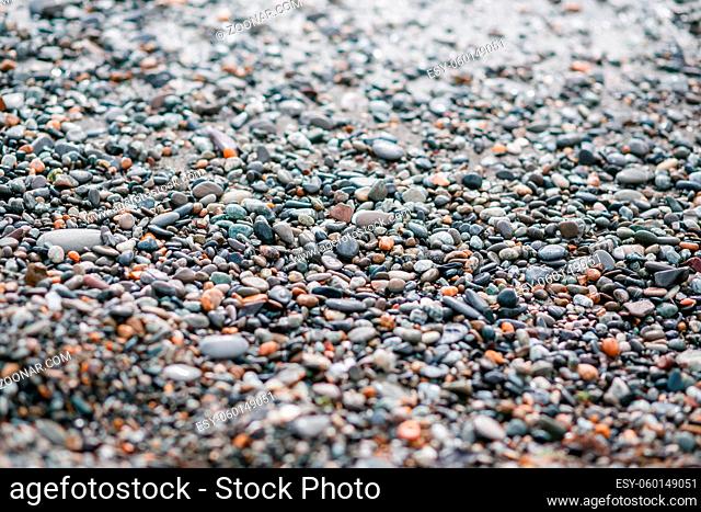 Nature background from gray sea pebbles. morning