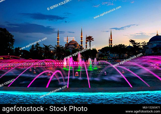 Blue Mosque illuminated at evening in Istanbul, Turkey. Inscription on a mosque is translated as On him is a soul of everyone