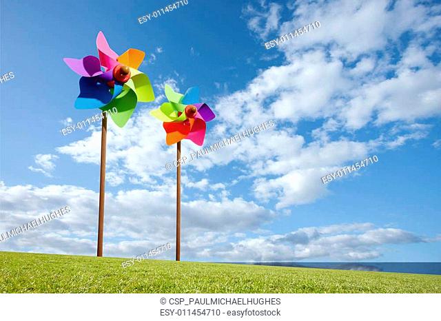 Toy windmill concept of green energy wind farm by the sea