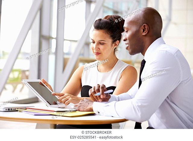 Two corporate business colleagues working together in office