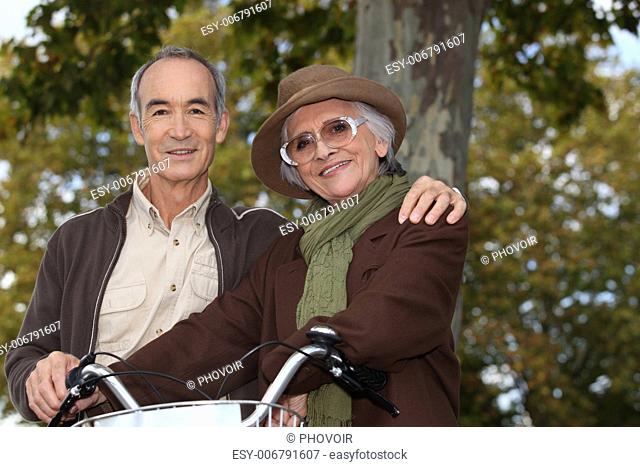 Elderly couple on a bike ride in the forest