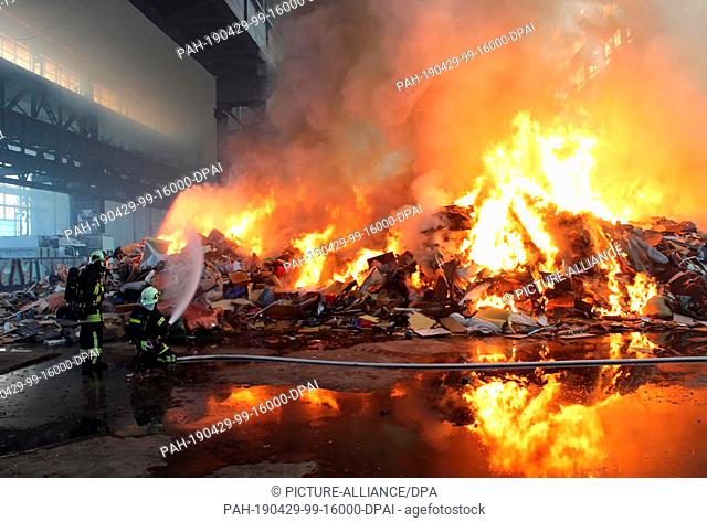 29 April 2019, Brandenburg, Brandenburg/Havel: Firefighters extinguish a fire in a recycling facility. Photo: meetingpoint-brandenburg/dpa-Zentralbild/ZB