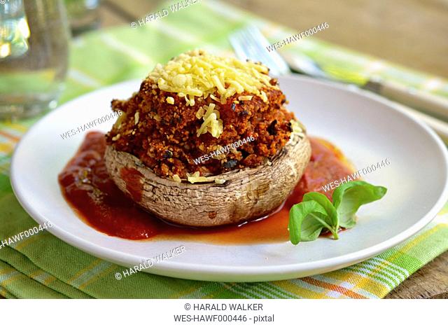 Walnut stuffed portobello mushrooms with vegan cheese and a tomato sauce