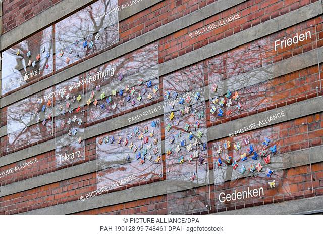 25 January 2019, Brandenburg, Cottbus: Ceramic butterflies can be seen on the façade of the ""Moving Primary School"" after the ceremonial inauguration of the...