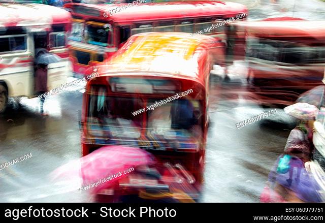 Blur night bus in rainy weather in Southeast Asia. A bunch of buses in motion at bus station