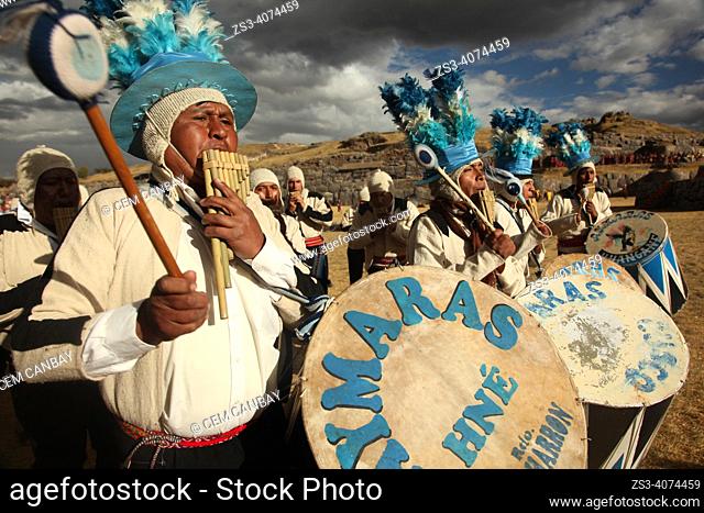Indigenous people with traditional costumes during a performance with their drums and pan flutes at the Inti Raymi Festival in Saqsaywaman Archaeological Site