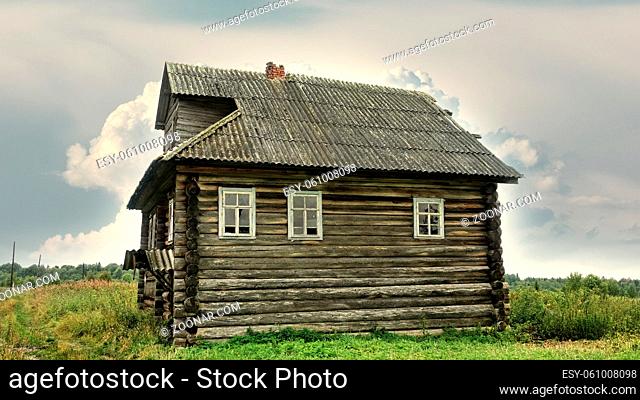 Old wooden house in Arkhangelsk region, a Residential village home in a forest village, Abandoned people and boarded up house. Russia