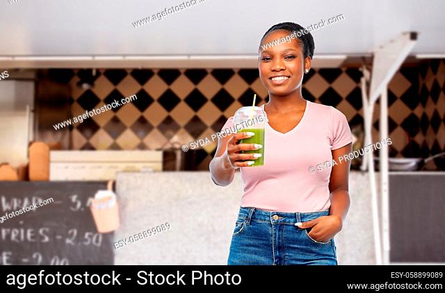 african american woman with juice over food truck