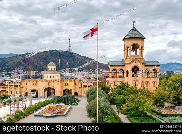 View of the main gate and bell tower on the territory of Holy Trinity Cathedral of Tbilisi, Georgia