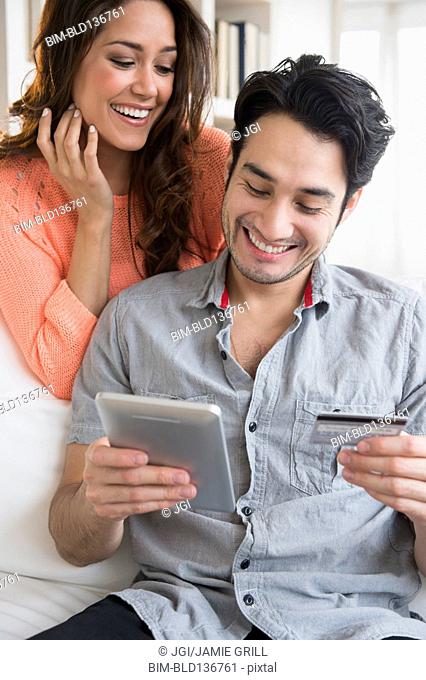 Couple shopping together on tablet computer