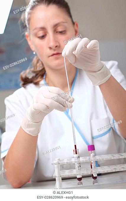 Woman doctor doing erythrocyte sedimentation rate test in laboratory