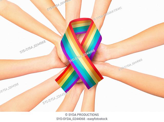 female hands holding gay pride awareness ribbon