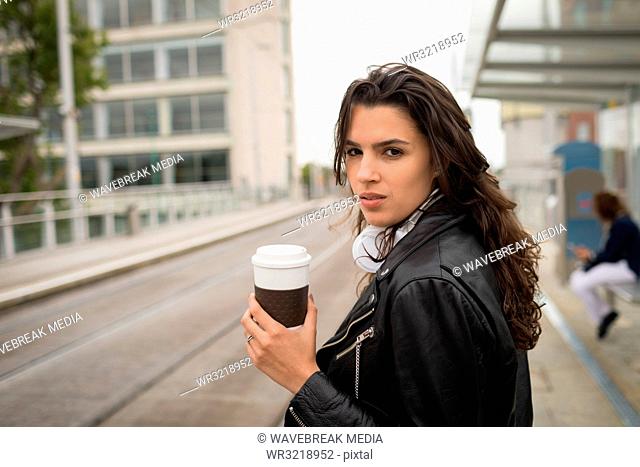 Woman having coffee in platform