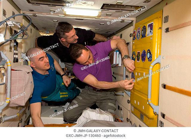 In the Zarya Functional Cargo Block (FGB), NASA astronaut Dan Burbank (center), Expedition 30 commander; along with Russian cosmonauts Anton Shkaplerov (right)...