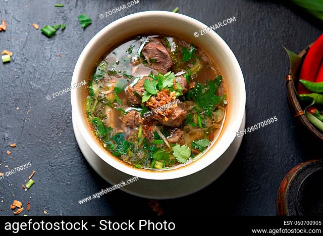 Asian bone soup or sup tulang, popular traditional malay dish. Top view flat lay