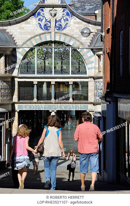 England, Norfolk, Norwich. A family entering the Royal Arcade, built in 1899 on the site of the yard of the Royal Hotel
