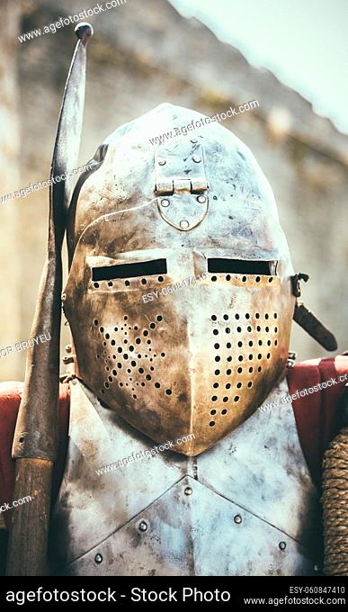 Medieval Knight In Helmet On Ancient Wall Background