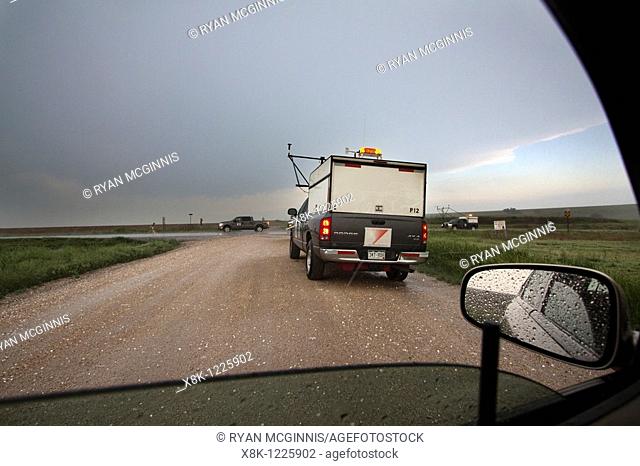 Project Vortex 2 storm chasers parked alongside the road in Kansas with hail on the ground, May 23, 2010  Project Vortex 2 is a two year government funded...