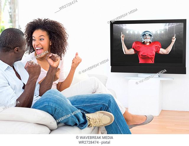 Couple watching american football at home